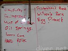 The list of dive sites the Sea Divers dove on the Peace's white board.