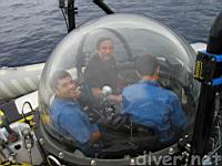 Chris and pilot Ofer look out as HDTV camera operator Nico looks down