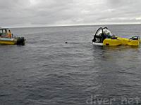 swimmer Rafael returns to the support boat after connecting the tow line to Deep See